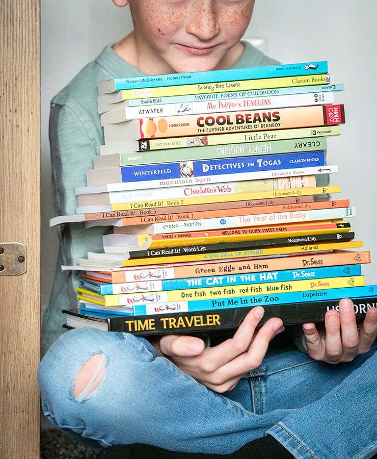 little boy with books