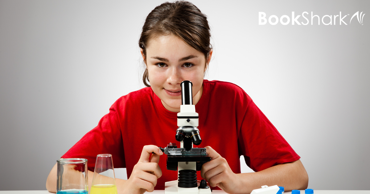 a middle schooler uses a microscope