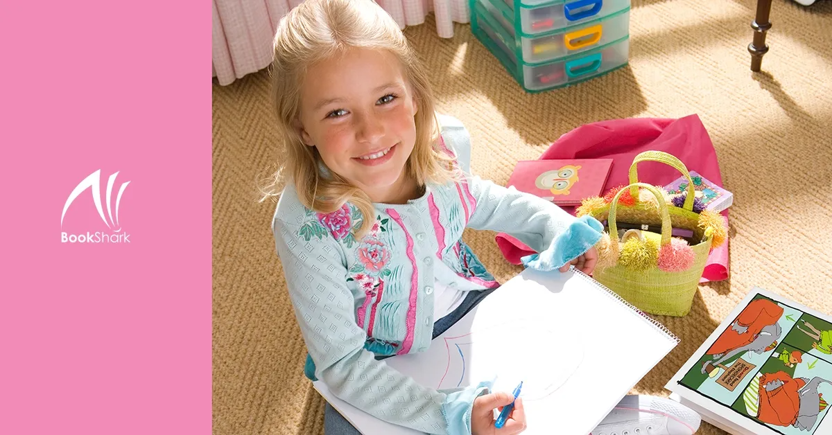 a girl draws with a big smile