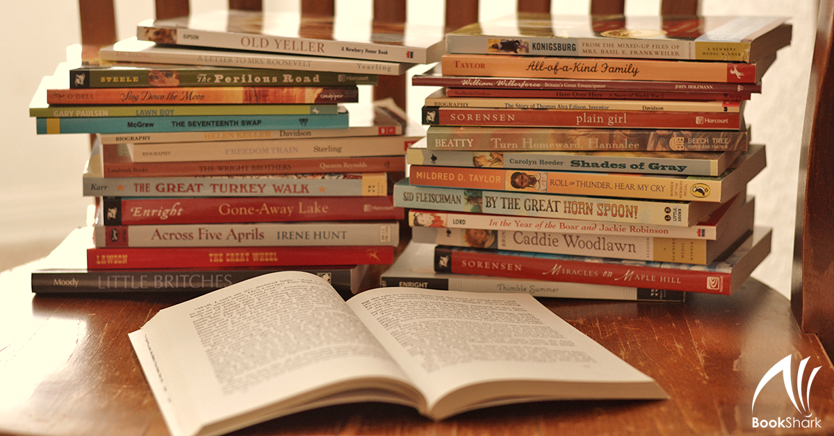 stacks of readers and read-alouds on a wooden chair